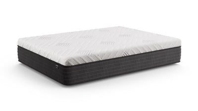 Low-angle view of the Gilded Mattress showing its quilted white top and dark gray base on a white background.