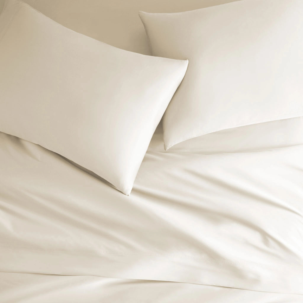 ivory bamboo bed sheets with sateen weave from the Signature Collection, overhead view highlighting smooth texture and matching pillowcases