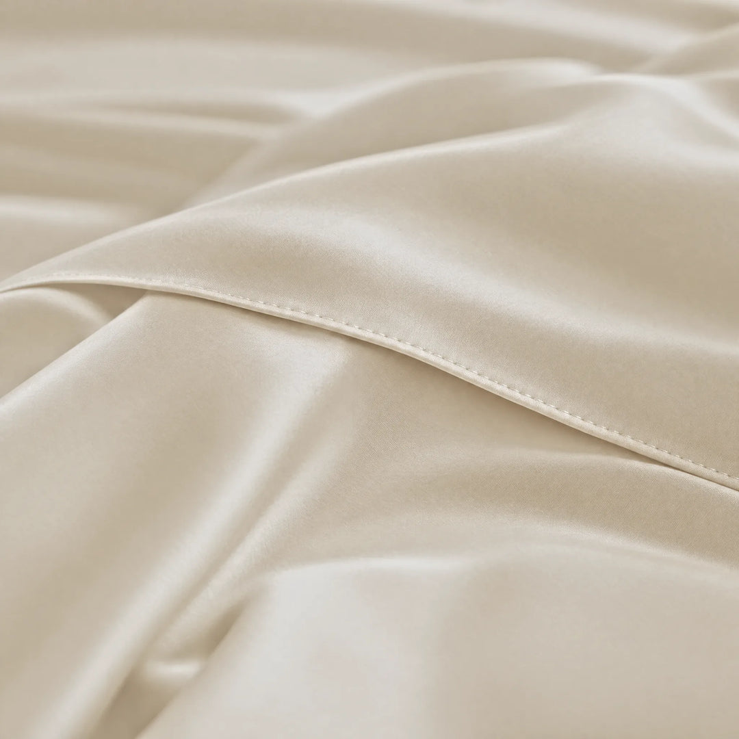 Ivory bamboo viscose sateen body pillowcase macro close-up of silky sateen folds and stitched envelope closure