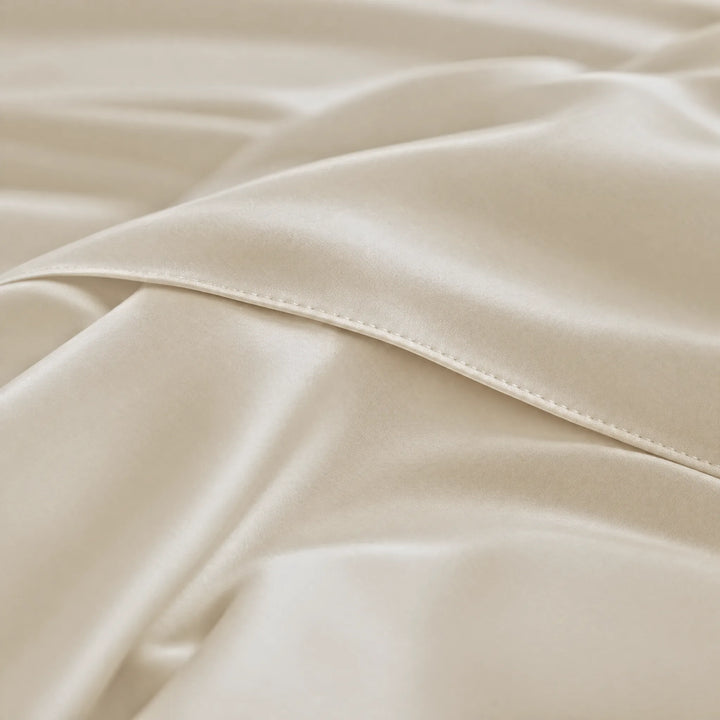 Ivory bamboo viscose sateen body pillowcase macro close-up of silky sateen folds and stitched envelope closure