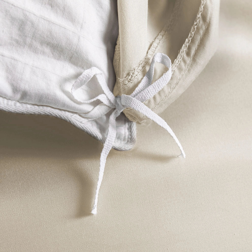 ivory bamboo duvet cover from the Signature Collection, close-up of internal corner tie securing white insert with smooth sateen fabric