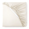 ivory bamboo sateen fitted sheet corner with white elastic strap, showing snug fit and smooth fabric texture