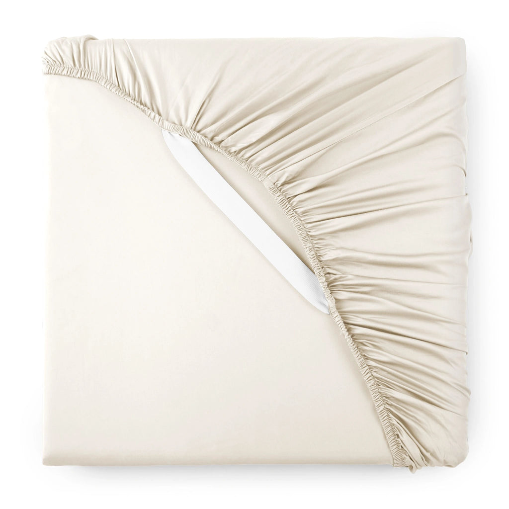 ivory bamboo sateen fitted sheet corner with white elastic strap, showing snug fit and smooth fabric texture