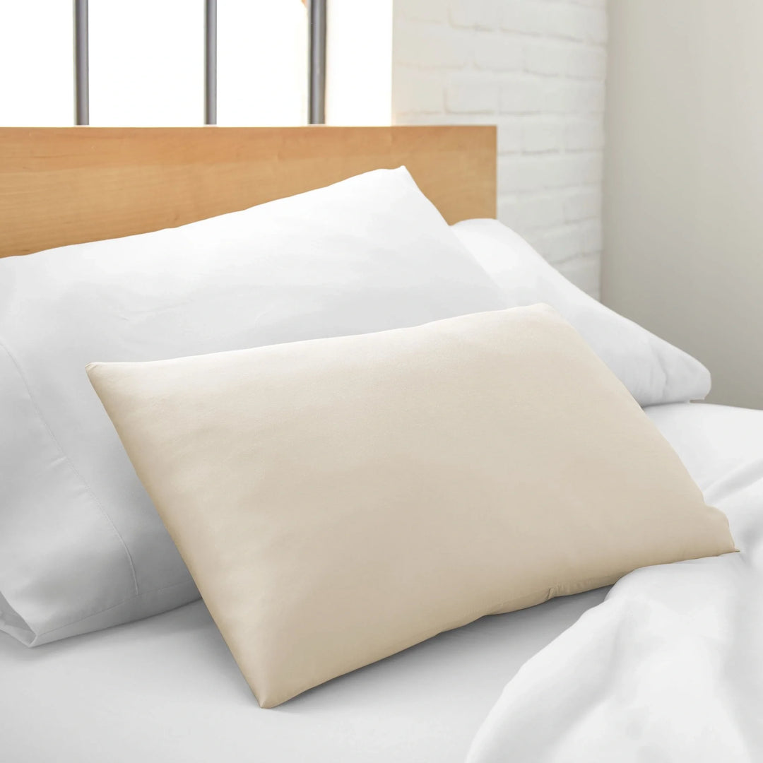 Ivory cooling bamboo spa pillowcase, silky sateen, styled on a bed