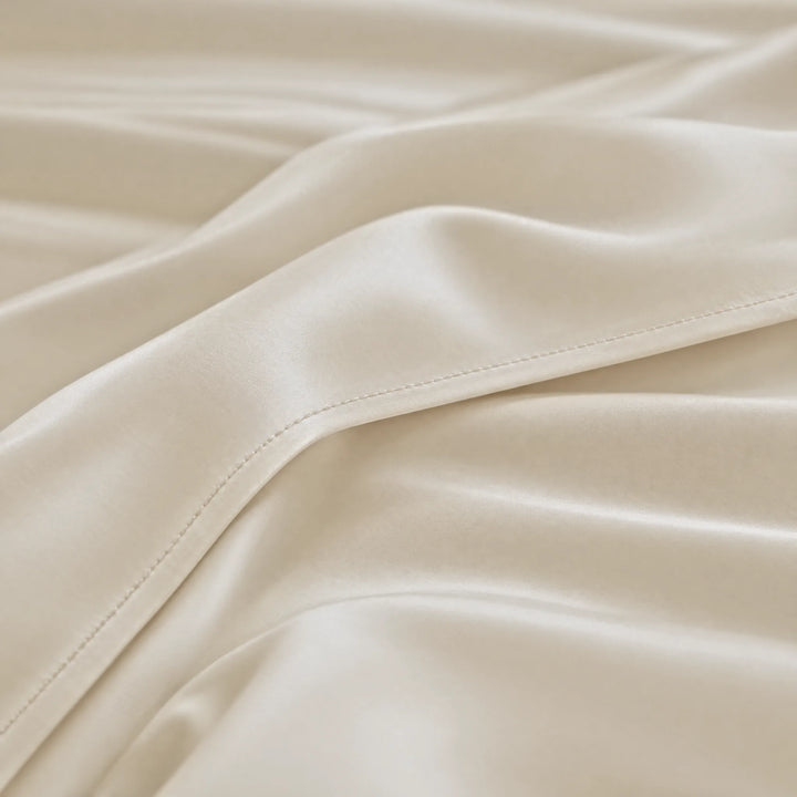 Ivory bamboo viscose sateen lumbar pillowcase macro close-up of silky sateen folds and stitched hem
