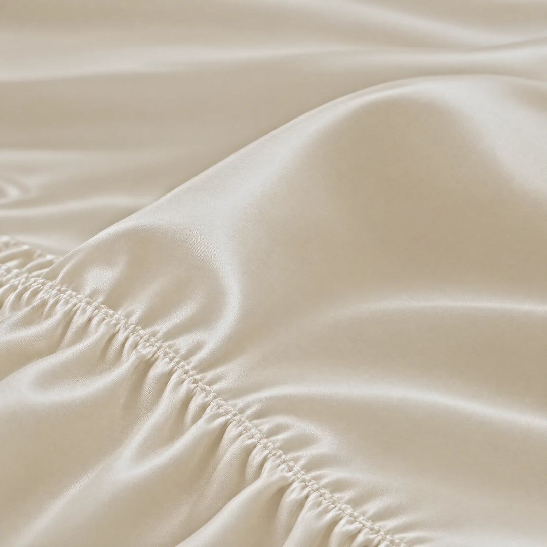 Ivory bamboo viscose fitted sheet stitched elastic hem macro close-up of smooth silky sateen, from the sheet set