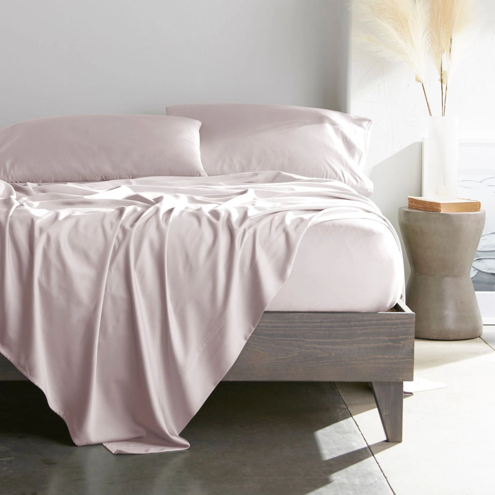 mauve bamboo bed sheets with sateen weave from the Premium Collection, shown from the foot of the bed with a draped flat sheet and matching pillowcases