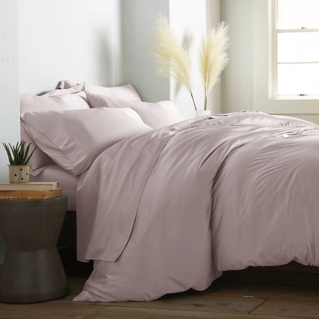 modern bedroom with mauve bamboo sateen sheet set on king bed, featuring matching pillowcases and duvet, styled with natural light and minimal decor
