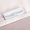 Mauve bamboo bed sheets with clearly labeled 'head' and 'foot' tags for easy bed-making