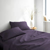 royal purple bamboo bed sheets with sateen weave from the Signature Collection, shown front view with matching pillowcases and a modern nightstand