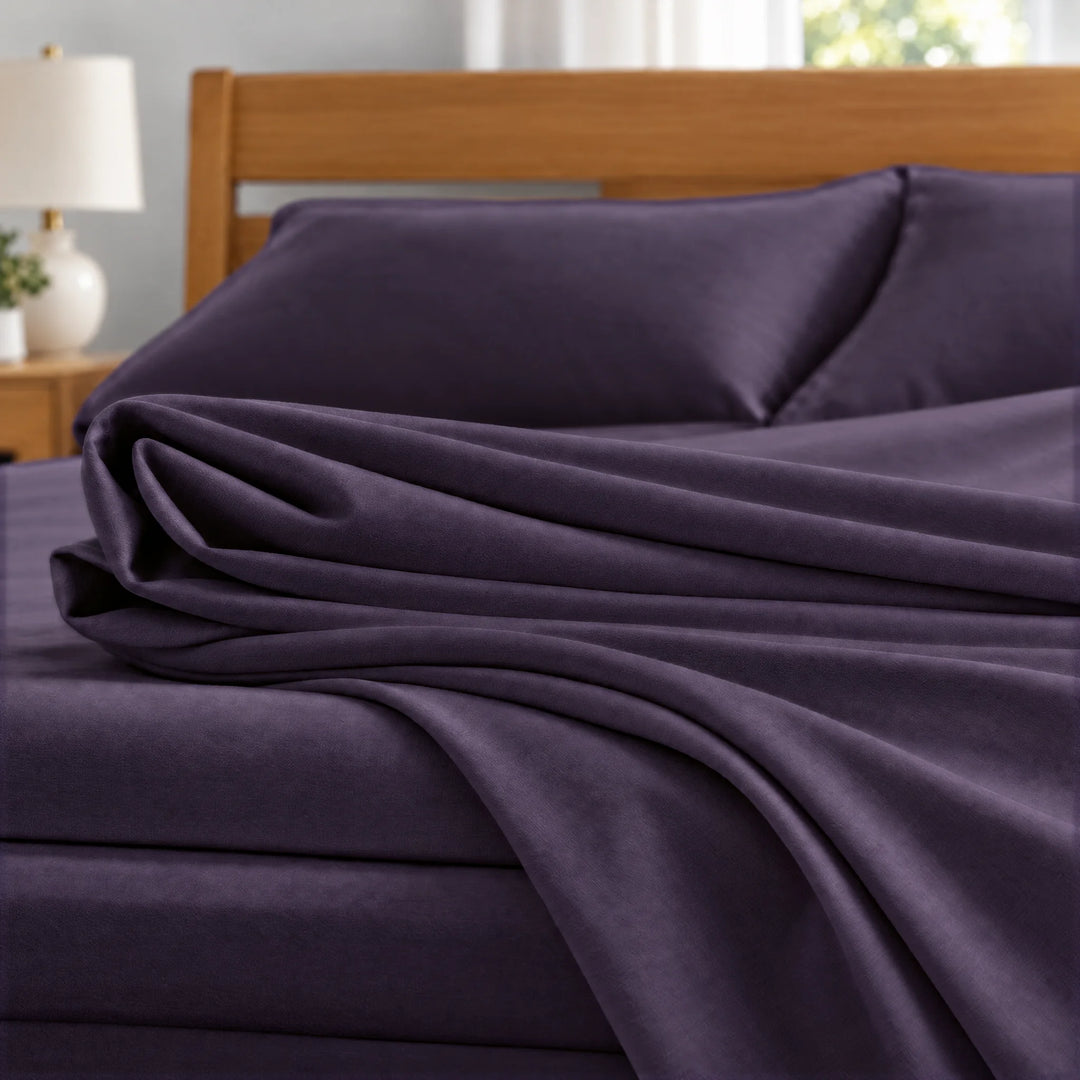 Royal Purple bamboo viscose sateen fabric close-up of folded sheets and a body pillowcase, silky sateen finish