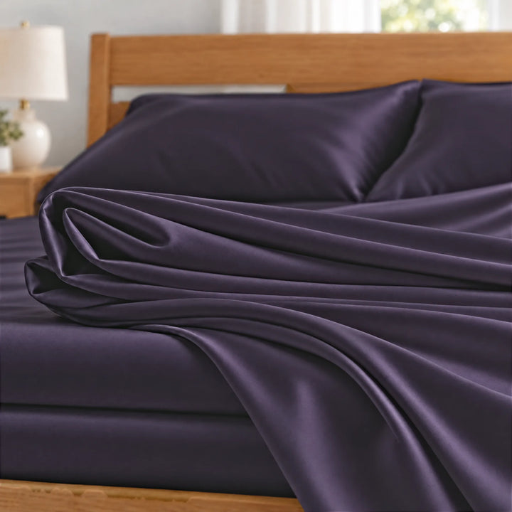 Royal Purple bamboo viscose sateen fabric close-up of folded sheets and a body pillowcase, silky sateen finish