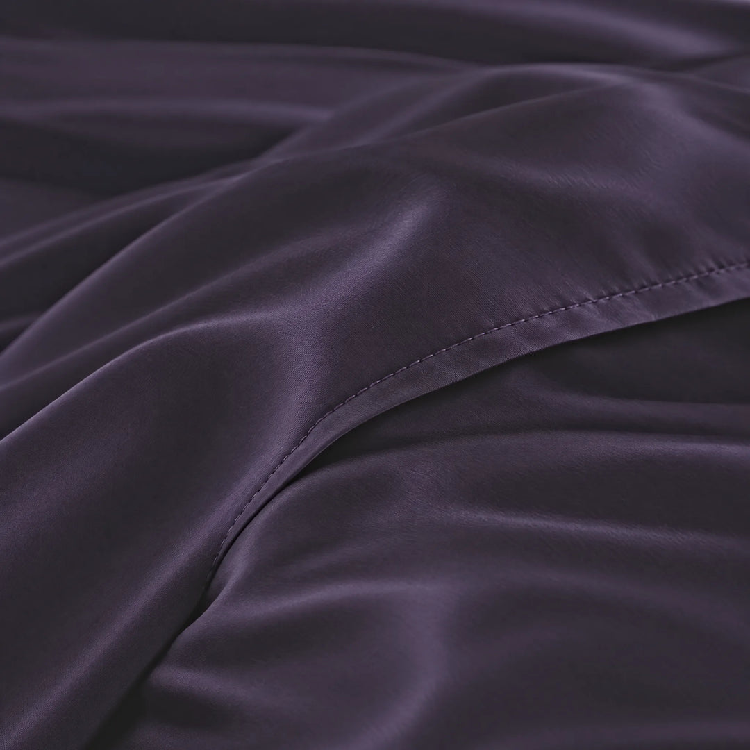 Royal Purple bamboo viscose sateen body pillowcase macro close-up of silky sateen folds and stitched envelope closure