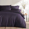 royal purple bamboo bed sheets with sateen weave from the Signature Collection, shown foot view with matching pillowcases and a modern nightstand