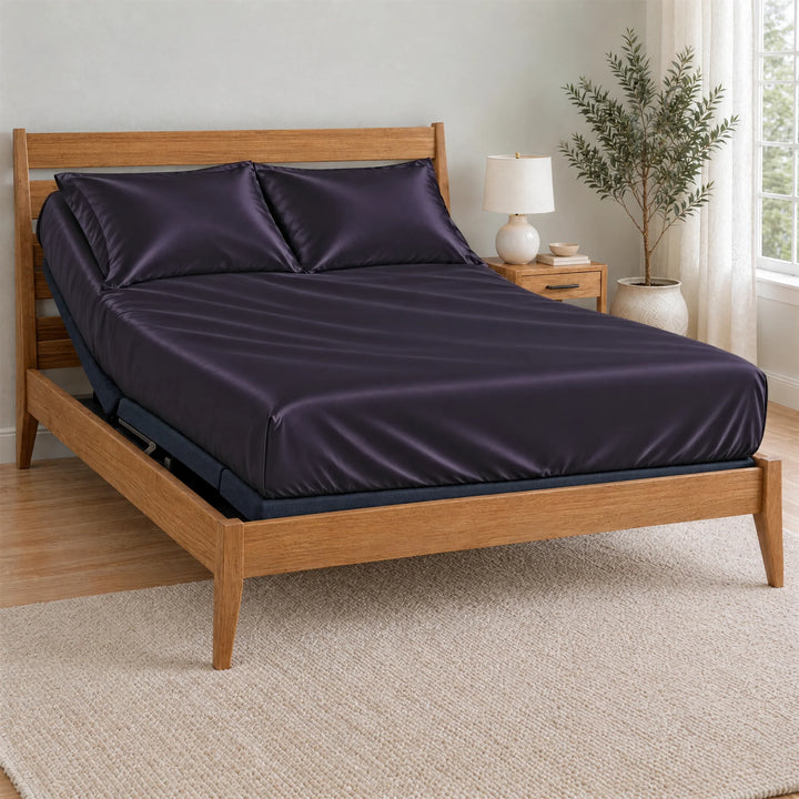 Royal Purple bamboo viscose Signature fitted sheet on a made bed with a bamboo frame and nightstand in a bright bedroom