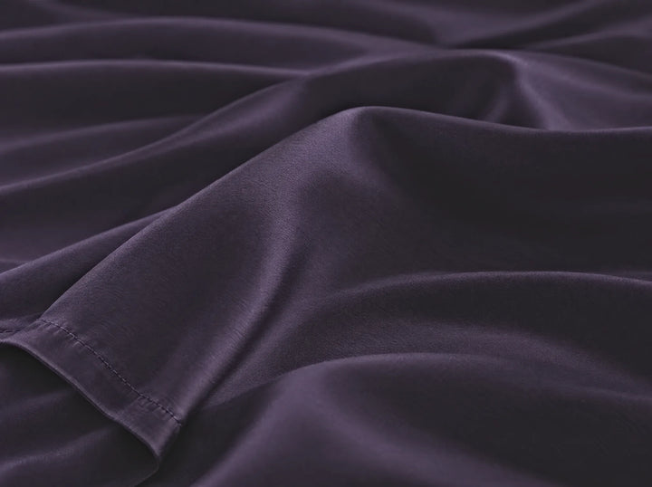 Royal Purple bamboo viscose flat sheet macro close-up of smooth silky sateen folds and a stitched hem