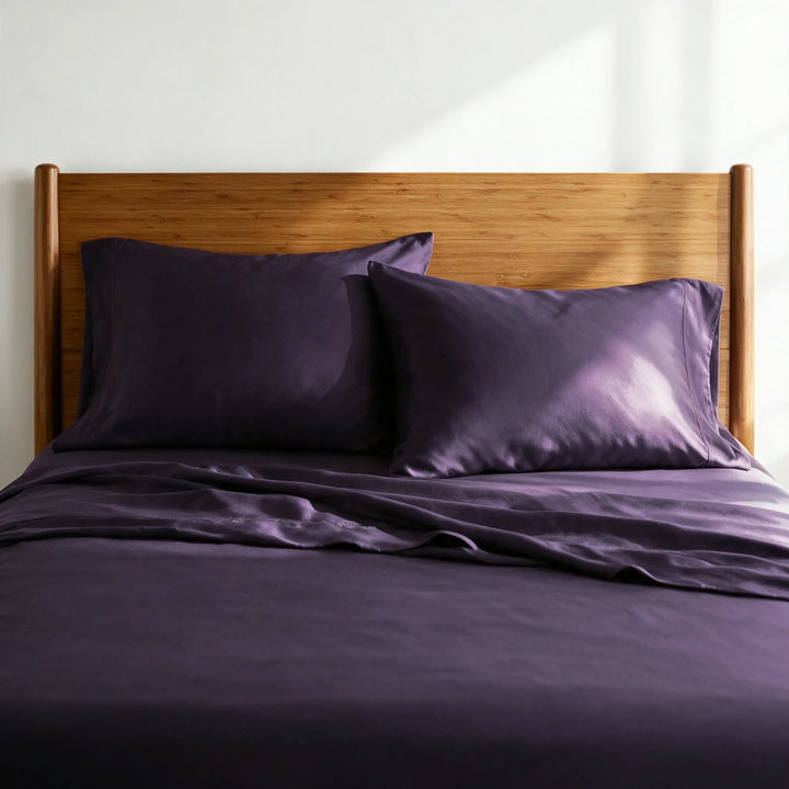 royal purple bamboo viscose sateen pillowcases against a caramelized bamboo headboard, showing the soft low-sheen finish