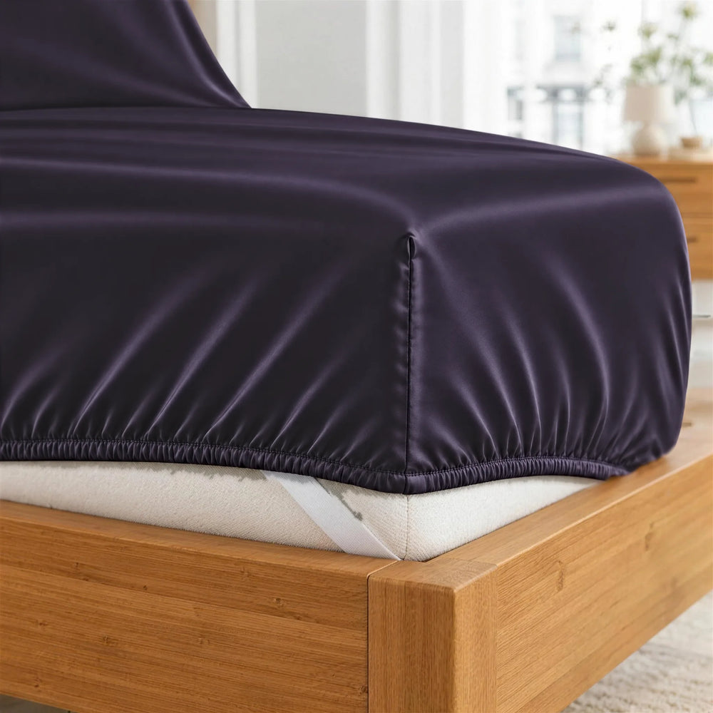 Royal Purple bamboo viscose fitted sheet deep-pocket corner close-up with all-around elastic and a corner strap, from the sheet set