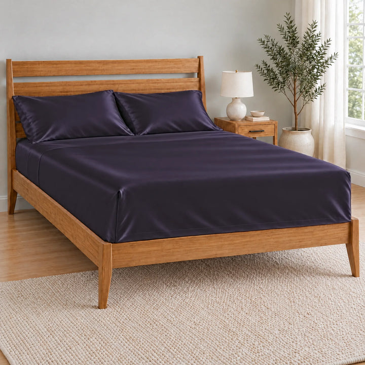 Royal Purple bamboo viscose flat sheet with a tucked hospital corner on a made bed, from the sheet set