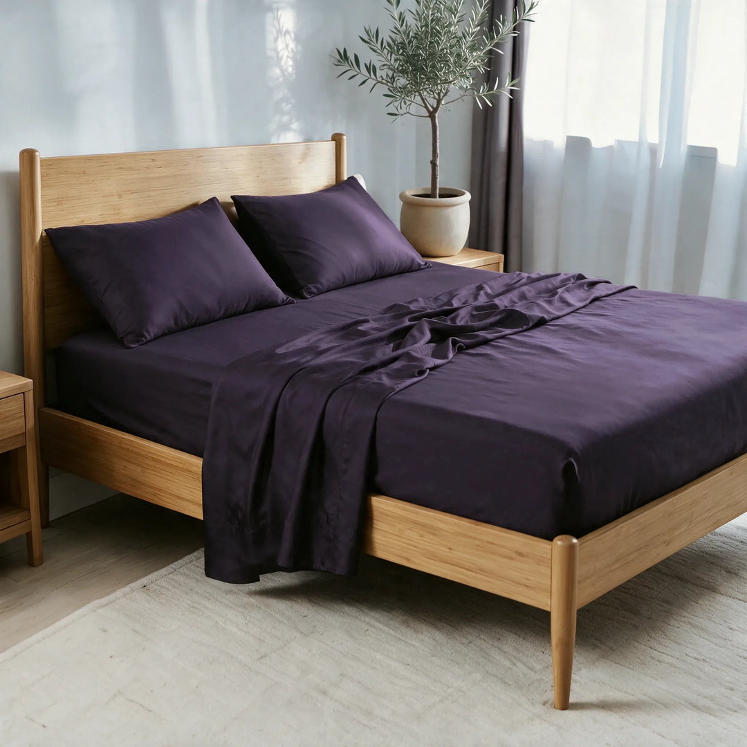 royal purple bamboo viscose sateen sheet set, three-quarter view with the flat sheet pulled back over the fitted sheet