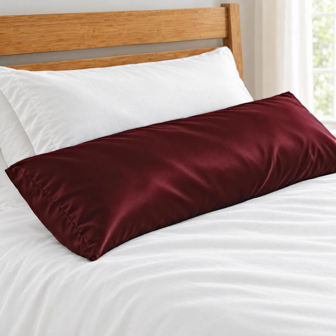 Ruby Red bamboo viscose sateen body pillowcase close-up on a body pillow beside a white sleeping pillow, silky sateen finish