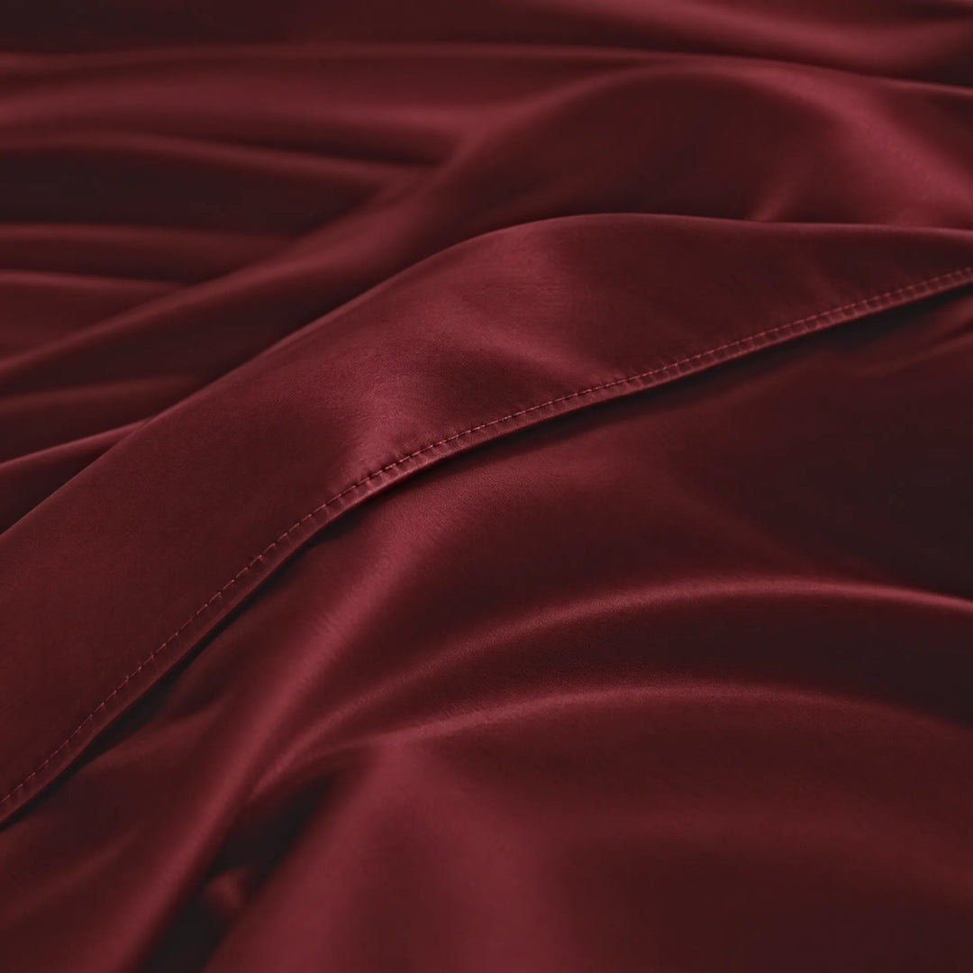 Ruby Red bamboo viscose sateen body pillowcase macro close-up of silky sateen folds and stitched envelope closure
