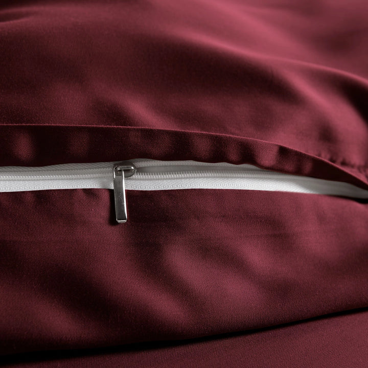close-up of ruby red bamboo pillowcase with hidden ruby red zipper and smooth sateen finish