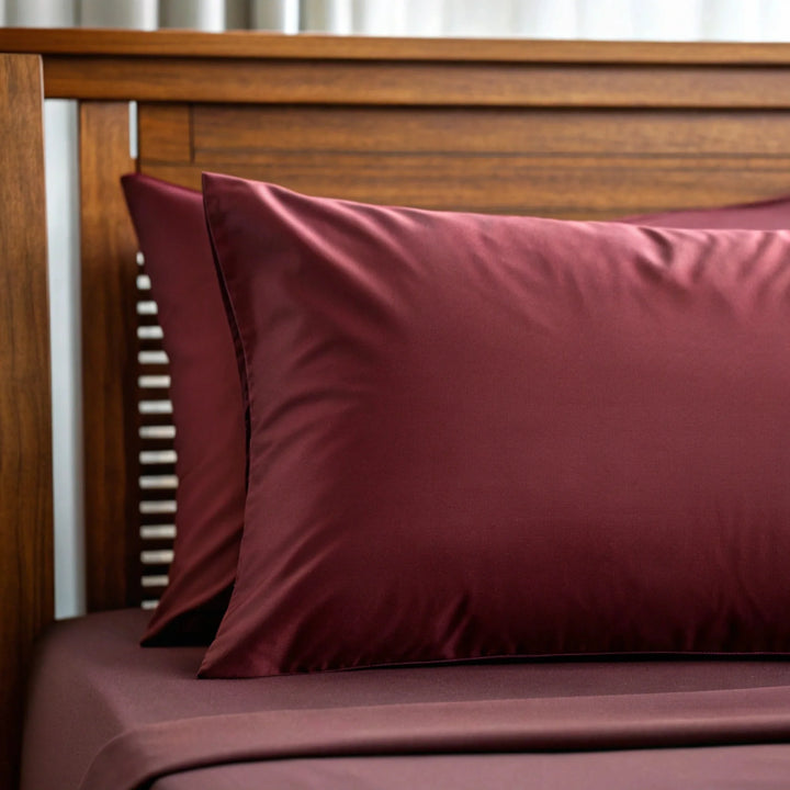 Ruby red bamboo sateen fabric close-up — the cooling weave used in the Toddler Pillowcase