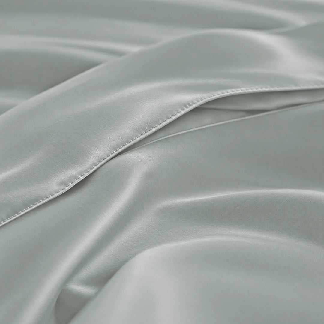 Silver bamboo viscose sateen body pillowcase macro close-up of silky sateen folds and stitched envelope closure