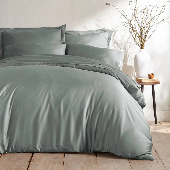 silver bamboo bed sheets with sateen weave from the Signature Collection, shown foot view with matching pillowcases and a modern nightstand