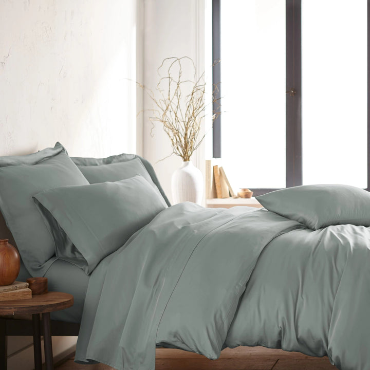 modern bedroom with silver bamboo sateen sheet set on king bed, featuring matching pillowcases and duvet, styled with natural light and minimal decor