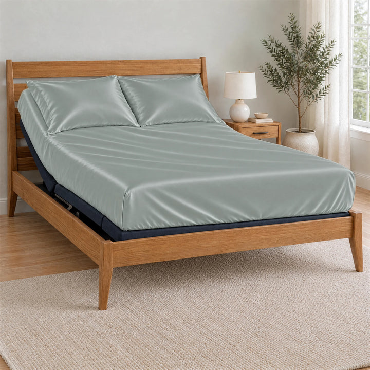 Silver bamboo viscose Signature fitted sheet on a made bed with a bamboo frame and nightstand in a bright bedroom