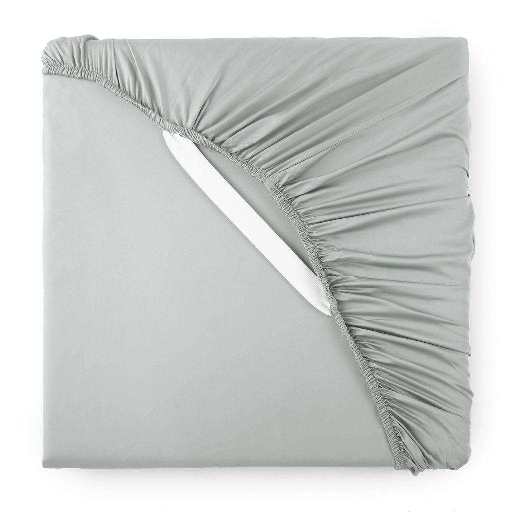 silver bamboo sateen fitted sheet corner with white elastic strap, showing snug fit and smooth fabric texture