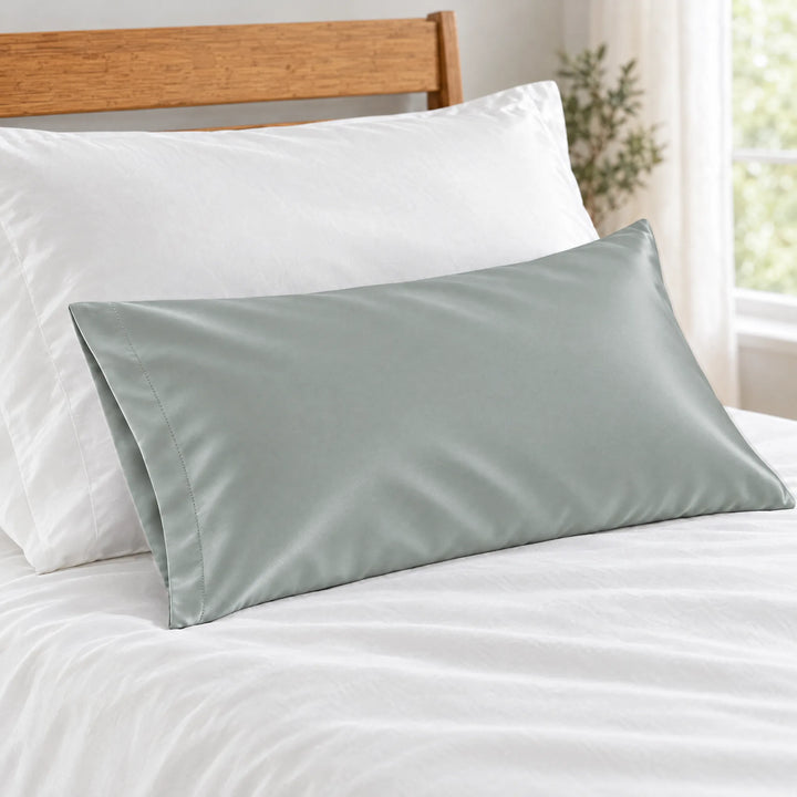 Silver bamboo viscose sateen lumbar pillowcase close-up on white bedding showing the silky sateen finish and stitched hem