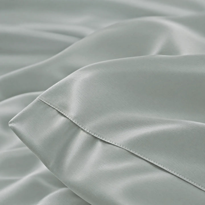 Silver bamboo viscose sateen lumbar pillowcase macro close-up of silky sateen folds and stitched hem