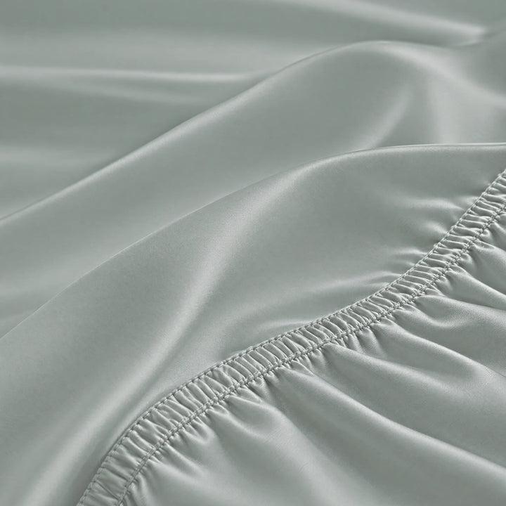 Silver bamboo viscose fitted sheet stitched elastic hem macro close-up of smooth silky sateen, from the sheet set