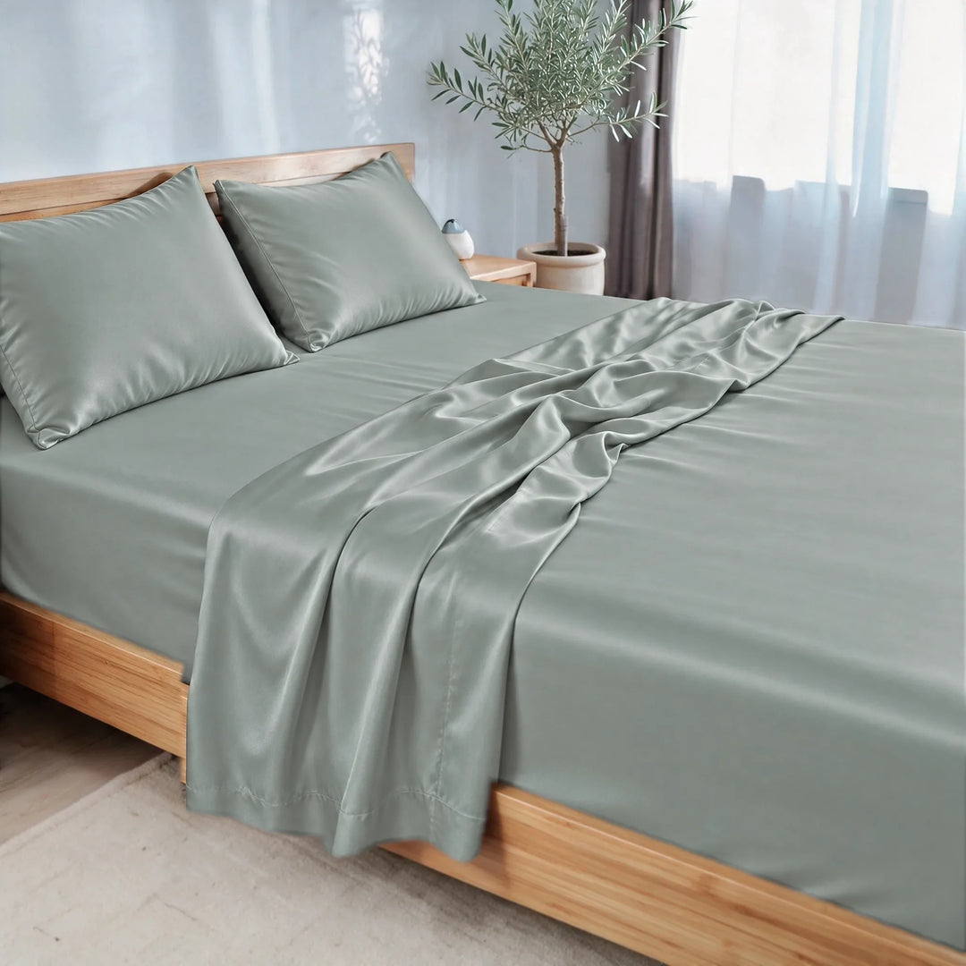 Silver bamboo viscose sateen sheet set, three-quarter view with the flat sheet pulled back over the fitted sheet