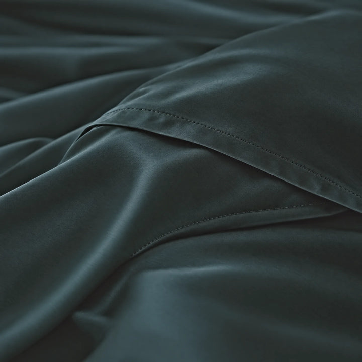 Slate bamboo viscose sateen body pillowcase macro close-up of silky sateen folds and stitched envelope closure
