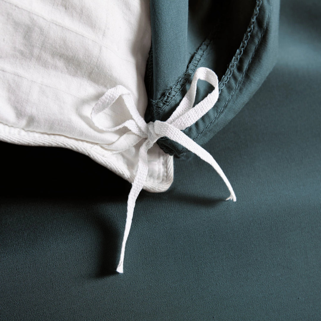 slate bamboo duvet cover from the Signature Collection, close-up of internal corner tie securing white insert with smooth sateen fabric