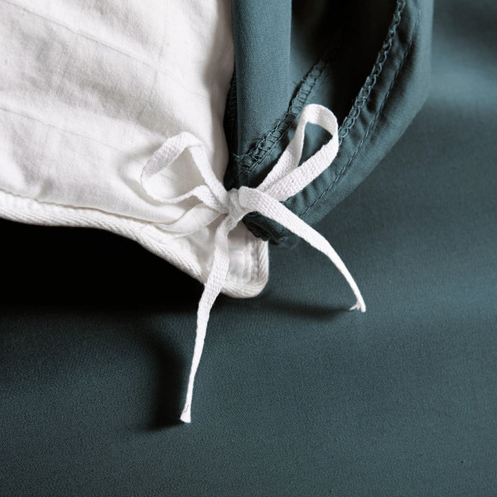 slate bamboo duvet cover from the Signature Collection, close-up of internal corner tie securing white insert with smooth sateen fabric