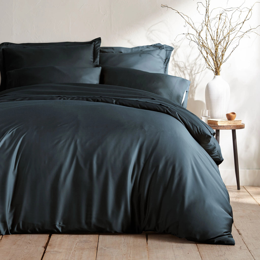 slate bamboo bed sheets with sateen weave from the Signature Collection, shown foot view with matching pillowcases and a modern nightstand