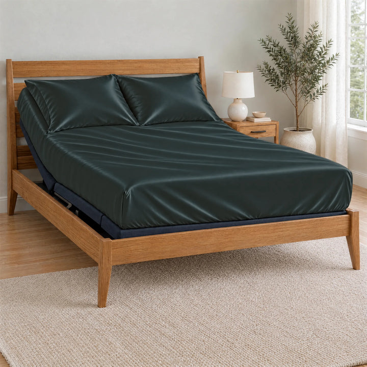 Slate bamboo viscose Signature fitted sheet on a made bed with a bamboo frame and nightstand in a bright bedroom