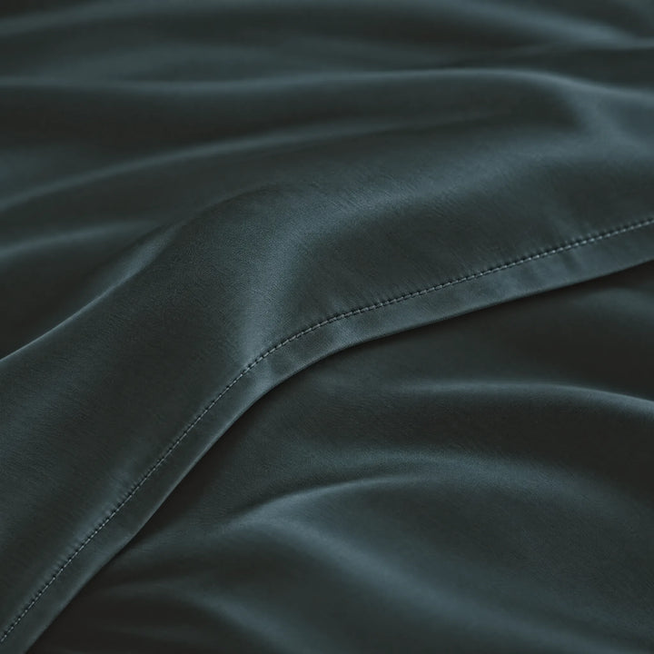 Slate bamboo viscose sateen lumbar pillowcase macro close-up of silky sateen folds and stitched hem