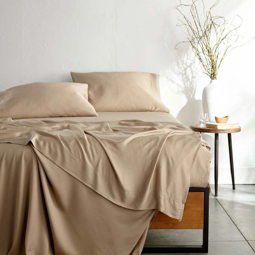 taupe bamboo bed sheets with sateen weave from the Signature Collection, shown from the foot of the bed with a draped flat sheet and matching pillowcases
