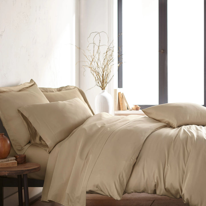 modern bedroom with taupe bamboo sateen sheet set on king bed, featuring matching pillowcases and duvet, styled with natural light and minimal decor