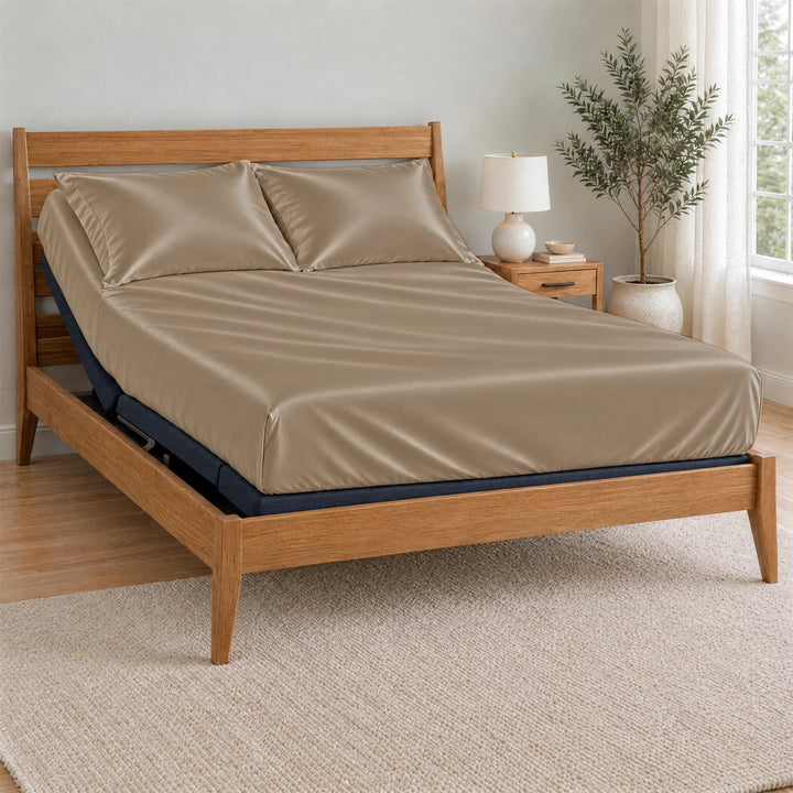 Taupe bamboo viscose Signature fitted sheet on a made bed with a bamboo frame and nightstand in a bright bedroom