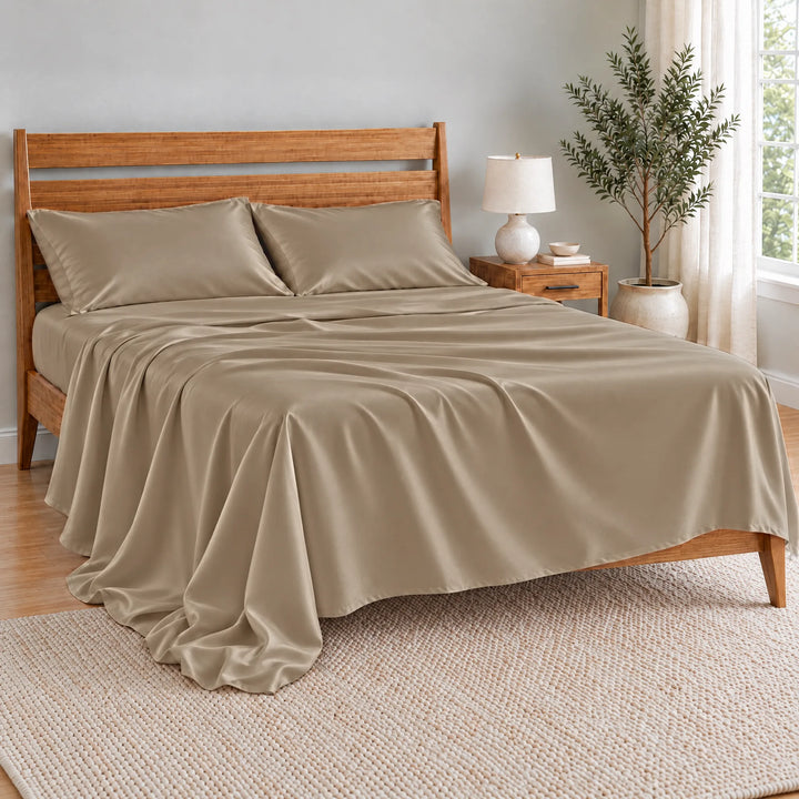 Taupe bamboo viscose flat sheet oversized and relaxed, spilling over the side of the bed in soft folds