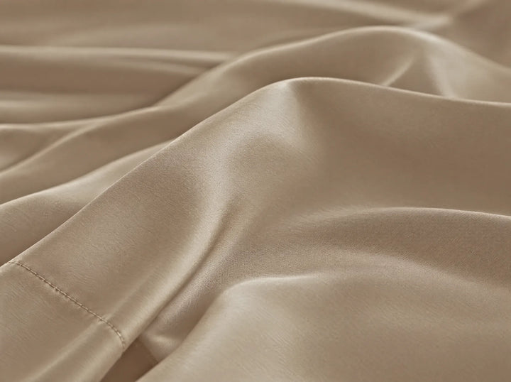 Taupe bamboo viscose flat sheet macro close-up of smooth silky sateen folds and a stitched hem