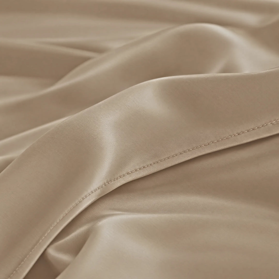 Taupe bamboo viscose sateen lumbar pillowcase macro close-up of silky sateen folds and stitched hem