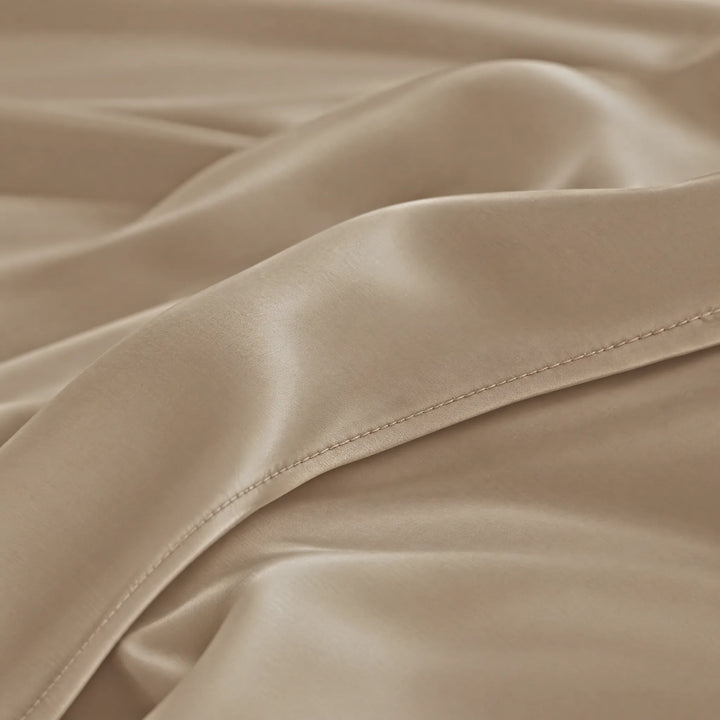 Taupe bamboo viscose sateen lumbar pillowcase macro close-up of silky sateen folds and stitched hem
